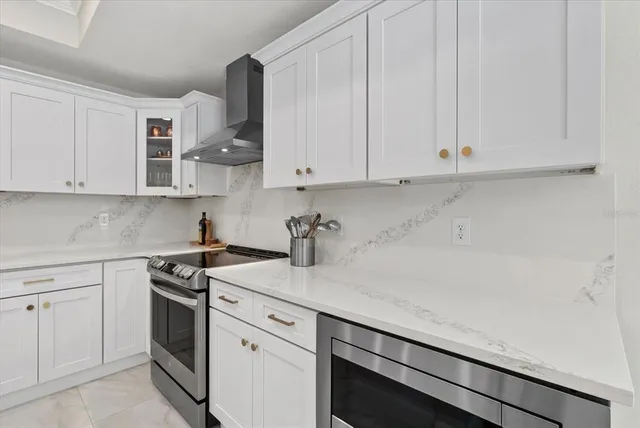 a kitchen with stainless steel appliances white cabinets and a sink