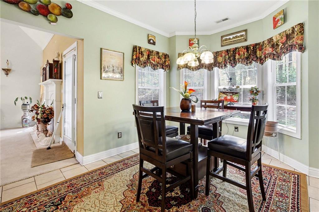 1041 Olive Drive Hampton, GA 30228 - Photo 11 of 29 a view of a dining room with furniture window and wooden floor