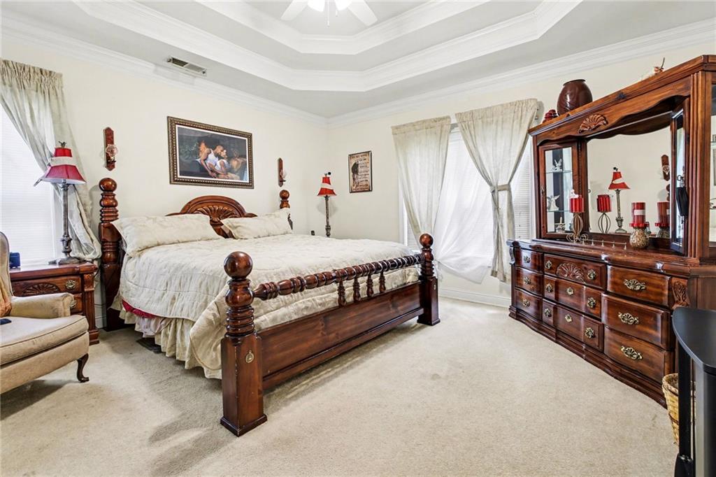 1041 Olive Drive Hampton, GA 30228 - Photo 14 of 29 a bedroom with a bed dresser and a large mirror