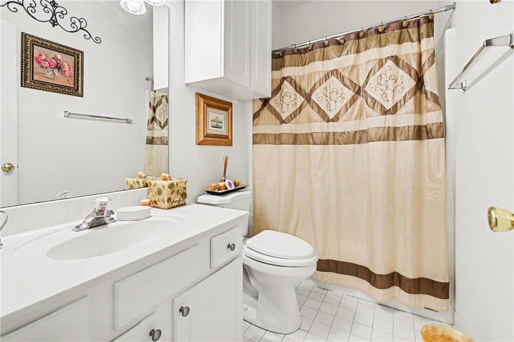 1041 Olive Drive Hampton, GA 30228 - Photo 20 of 29 a bathroom with a sink and a mirror
