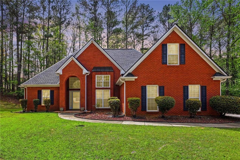 1041 Olive Drive Hampton, GA 30228 - Photo 2 of 29 a front view of a house with a yard and porch
