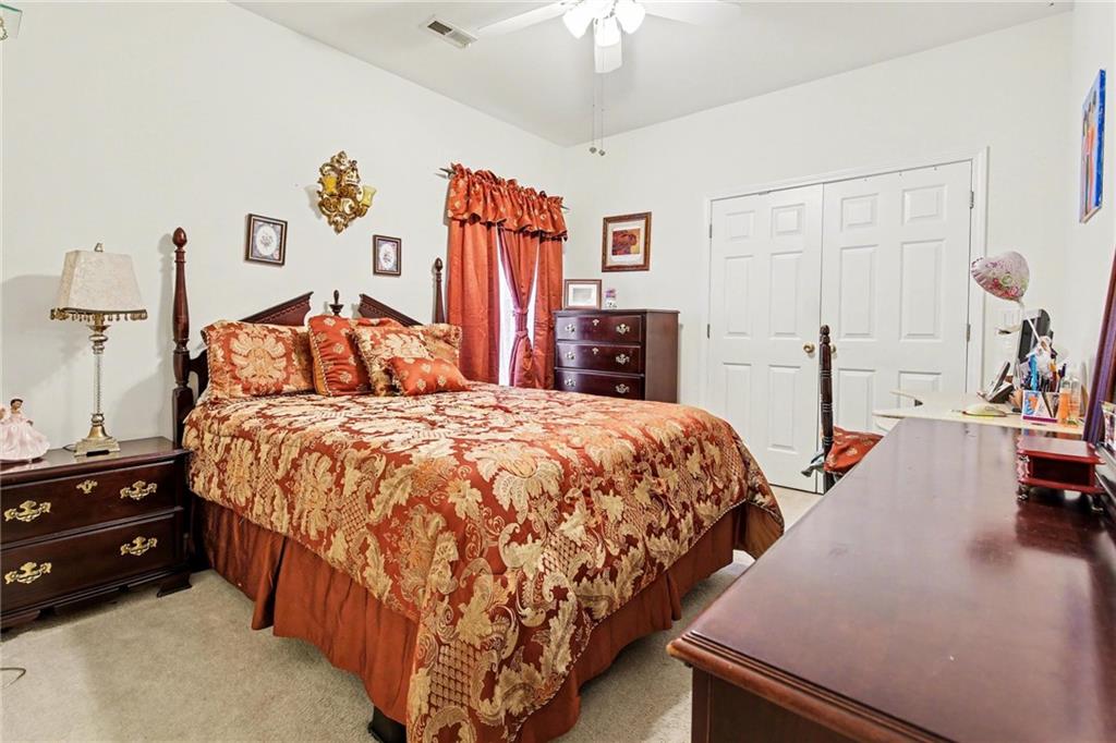 1041 Olive Drive Hampton, GA 30228 - Photo 21 of 29 a bed room with a bed and a couch