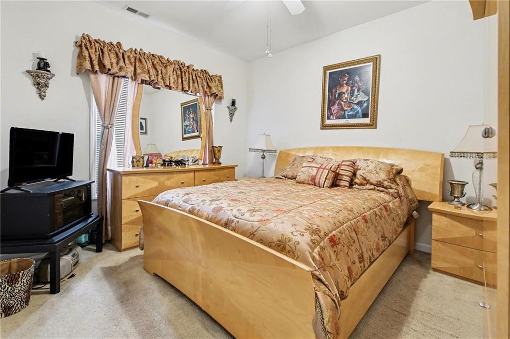 1041 Olive Drive Hampton, GA 30228 - Photo 22 of 29 a bedroom with a bed and a television