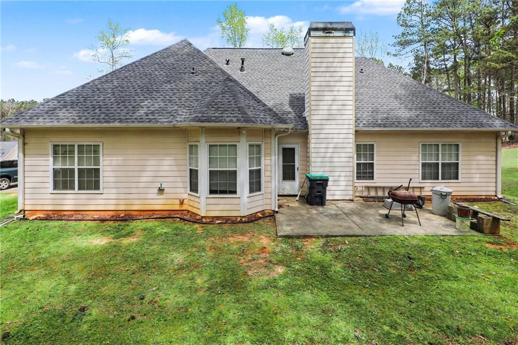 1041 Olive Drive Hampton, GA 30228 - Photo 24 of 29 a view of a house with a backyard and sitting area
