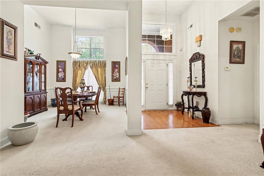 1041 Olive Drive Hampton, GA 30228 - Photo 9 of 29 a dining room with furniture and a floor to ceiling window