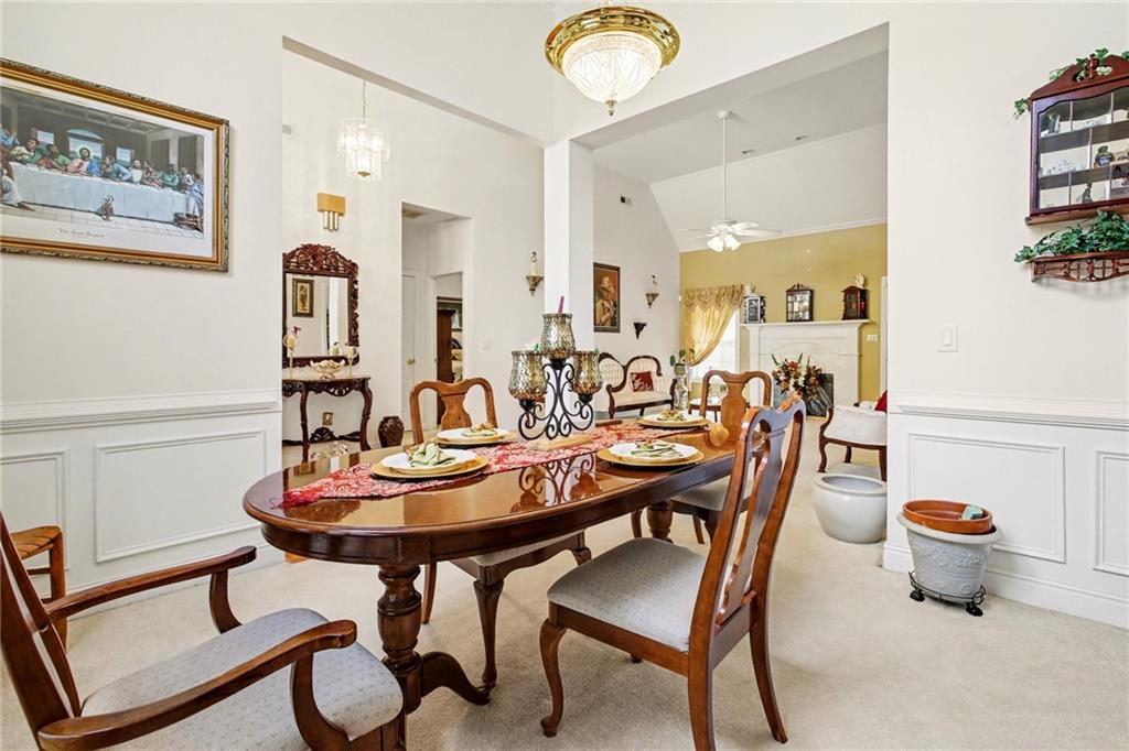 1041 Olive Drive Hampton, GA 30228 - Photo 10 of 29 a view of a dining room with furniture and a chandelier