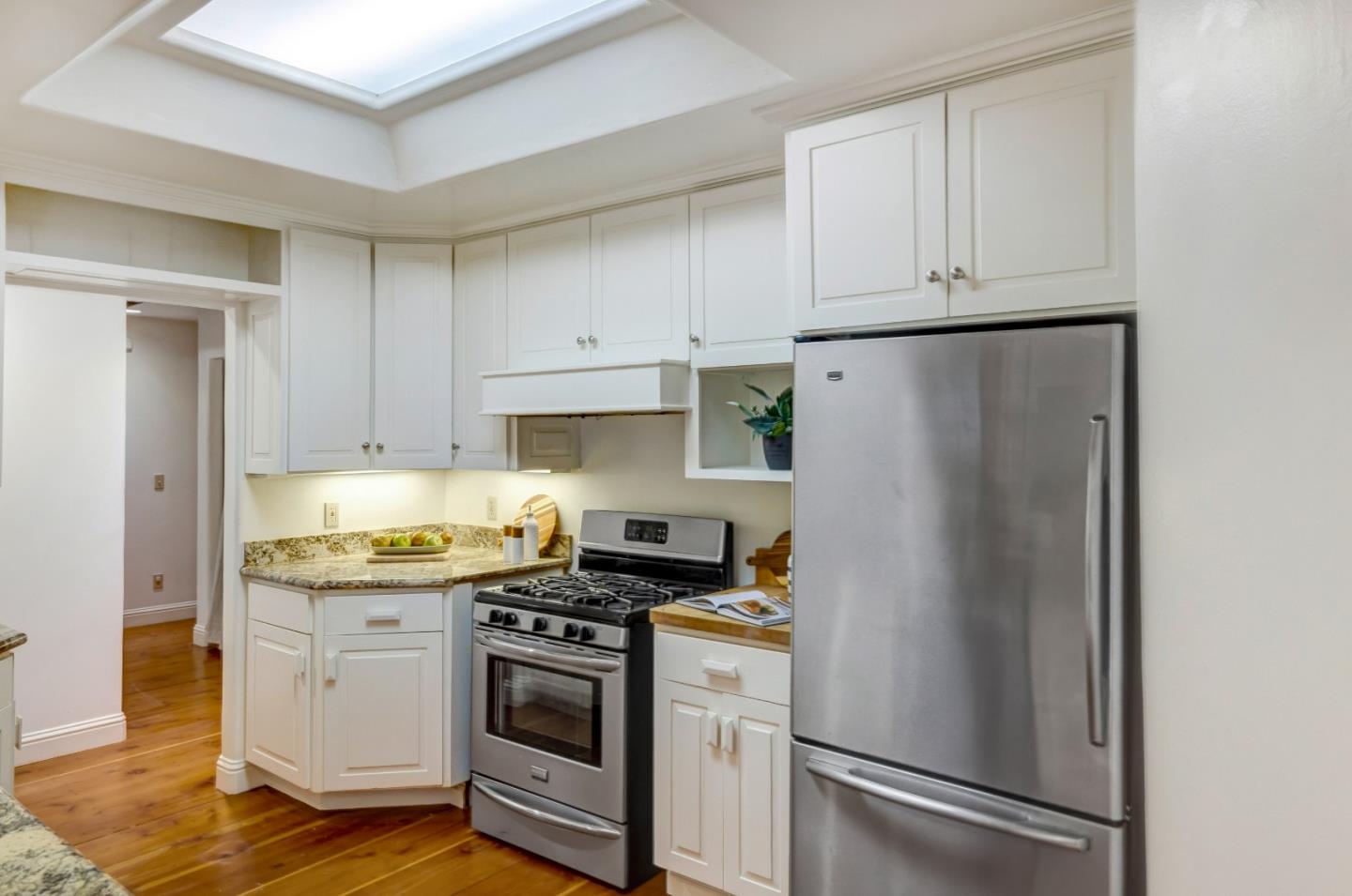 1166 Josselyn Canyon Road Monterey, CA 93940 - Photo 7 of 17 a kitchen with stainless steel appliances white cabinets and a refrigerator