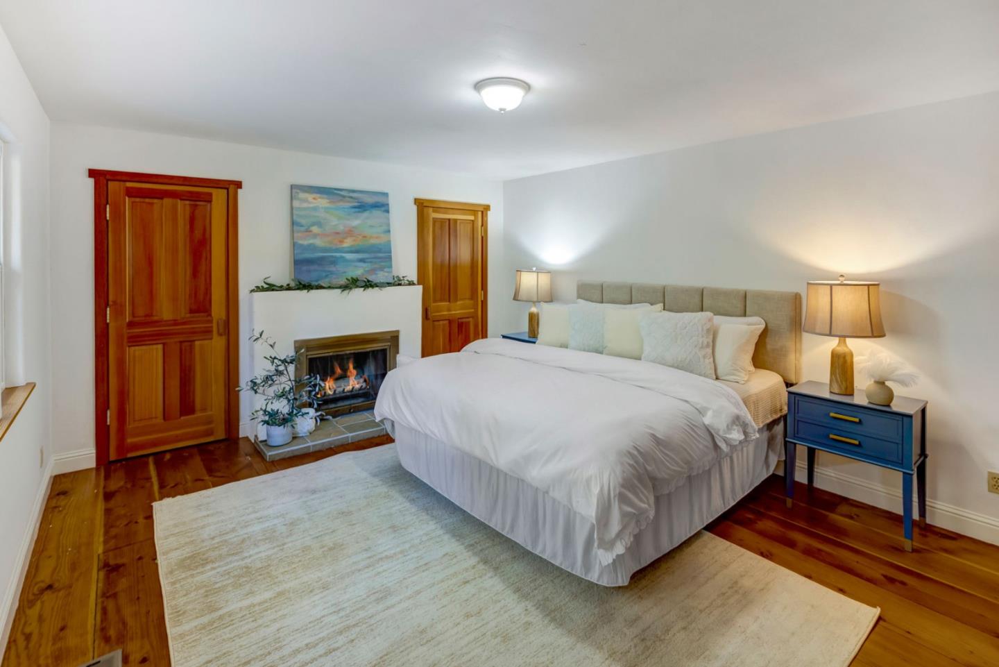 1166 Josselyn Canyon Road Monterey, CA 93940 - Photo 9 of 17 a bedroom with a bed and a fireplace