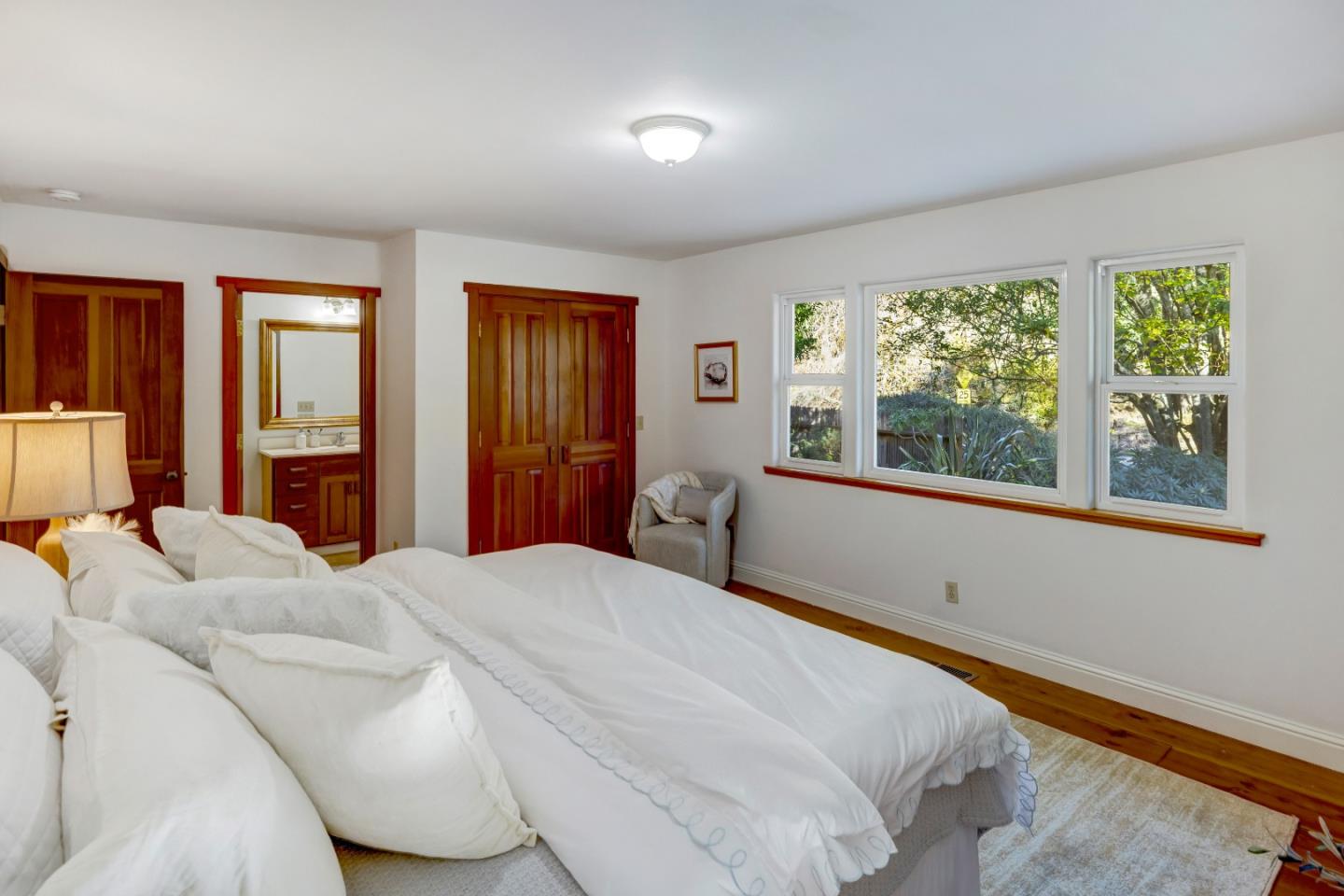 1166 Josselyn Canyon Road Monterey, CA 93940 - Photo 10 of 17 a bedroom with a large bed and a large window