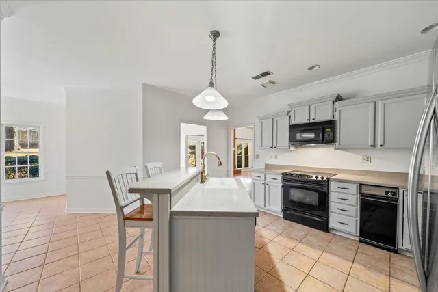 a large kitchen with sink cabinets and stainless steel appliances