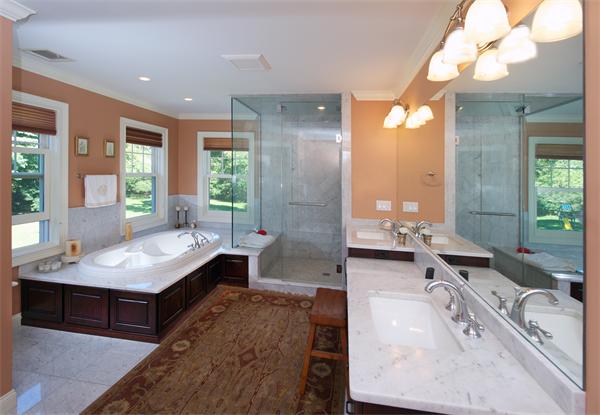 32 Winter Street Weston, MA 02493 - Photo 11 of 23 a large bathroom with a tub a double vanity sink a vanity and a large mirror