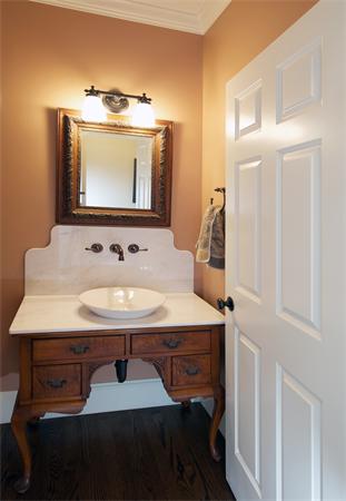 32 Winter Street Weston, MA 02493 - Photo 13 of 23 a room with a sink a mirror and lamp