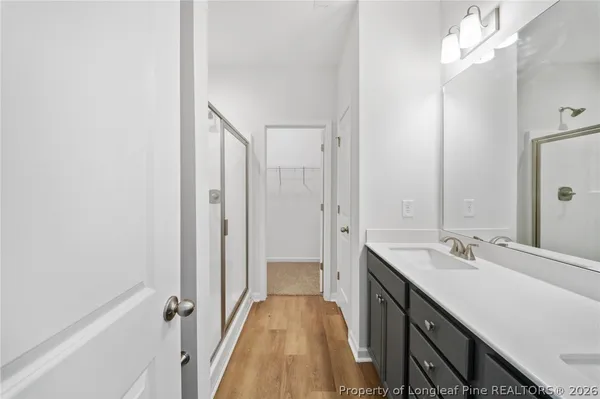 a bathroom with a sink a mirror and a shower
