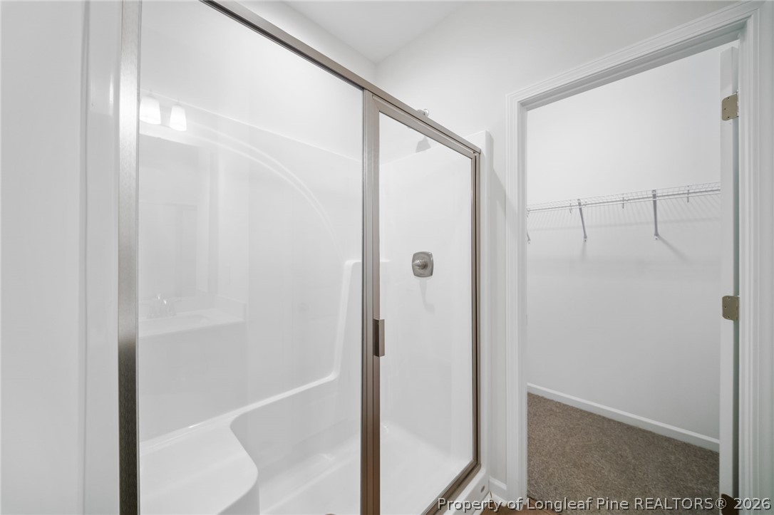 4043 Church Street Wade, NC 28395 - Photo 18 of 28 a bathroom with a glass shower door