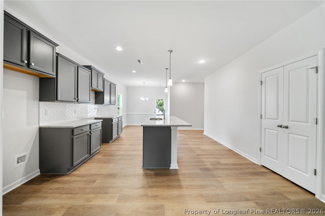 4043 Church Street Wade, NC 28395 - Photo 6 of 28 a large kitchen with a large counter top a sink stainless steel appliances and cabinets