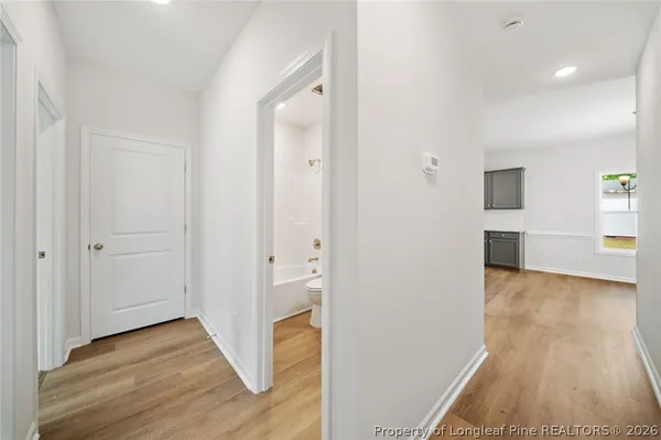a view of hallway with wooden floor