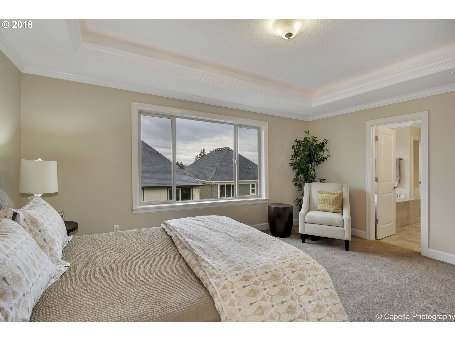 4178 Northwest Ashbrook Drive Portland, OR 97229 - Photo 12 of 20 a bedroom with a large bed and a couch