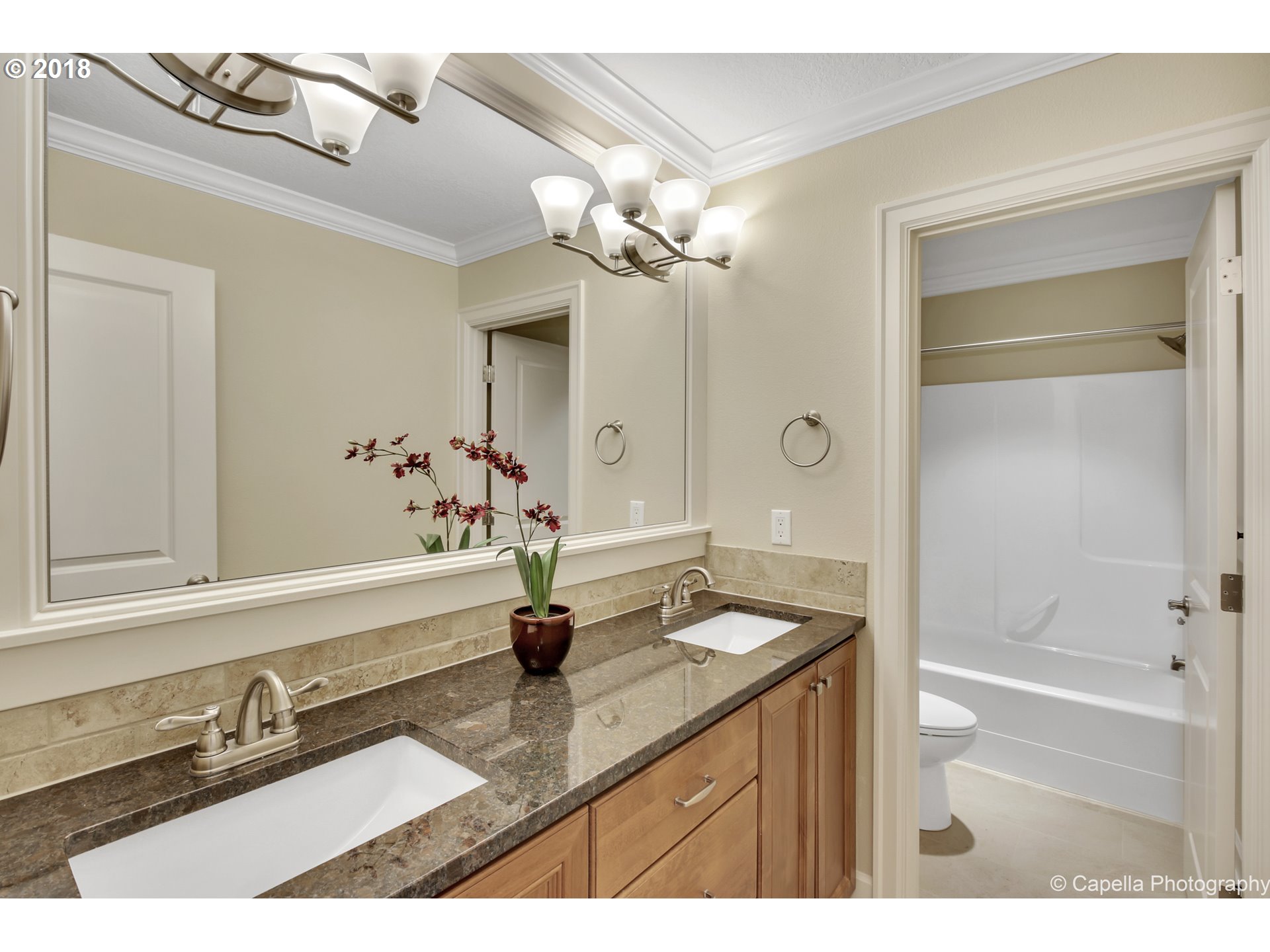4178 Northwest Ashbrook Drive Portland, OR 97229 - Photo 16 of 20 a bathroom with a granite countertop sink a light fixture and a mirror