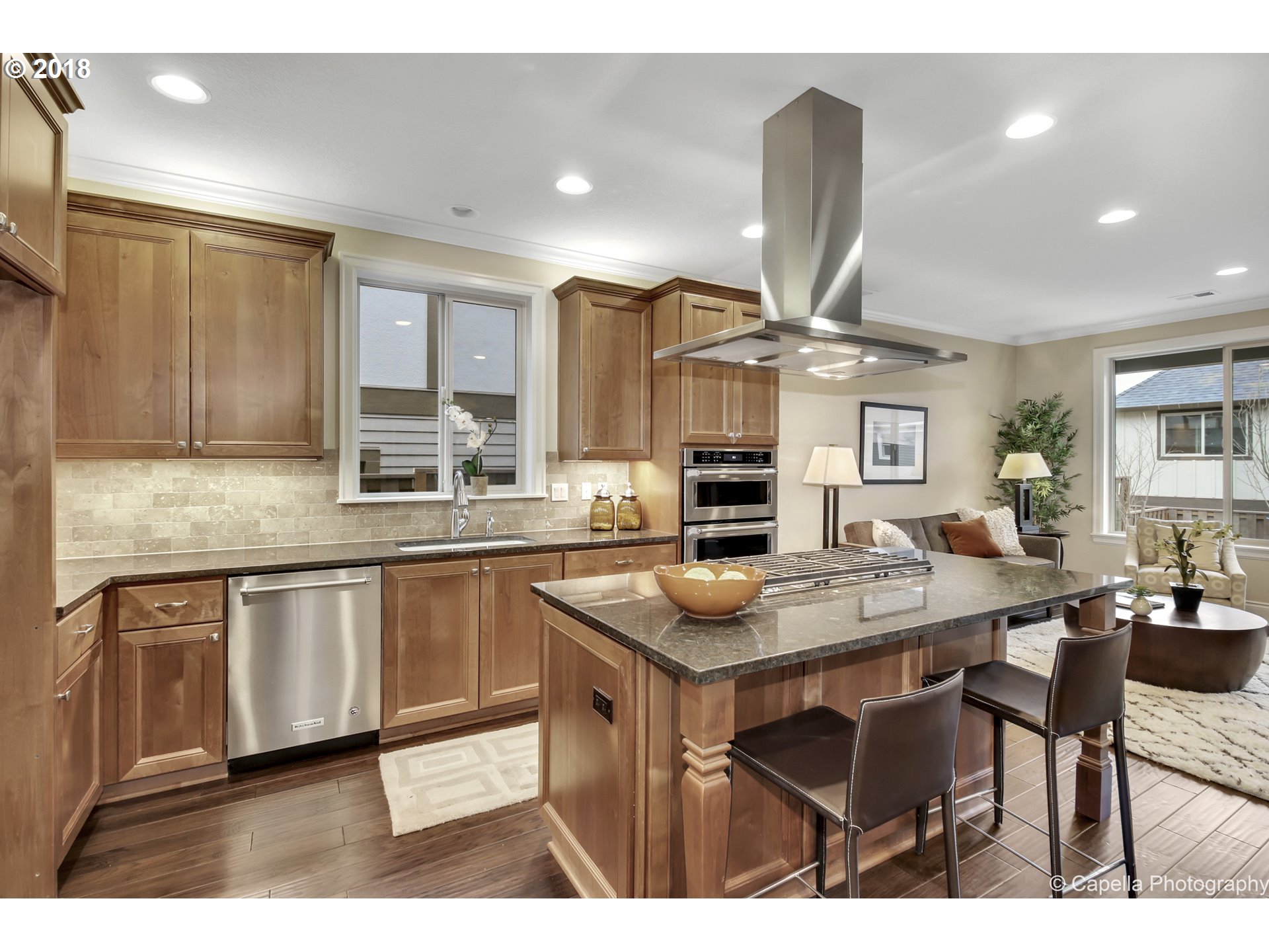 4178 Northwest Ashbrook Drive Portland, OR 97229 - Photo 2 of 20 a kitchen with stainless steel appliances granite countertop a sink a stove a refrigerator a dining table and chairs
