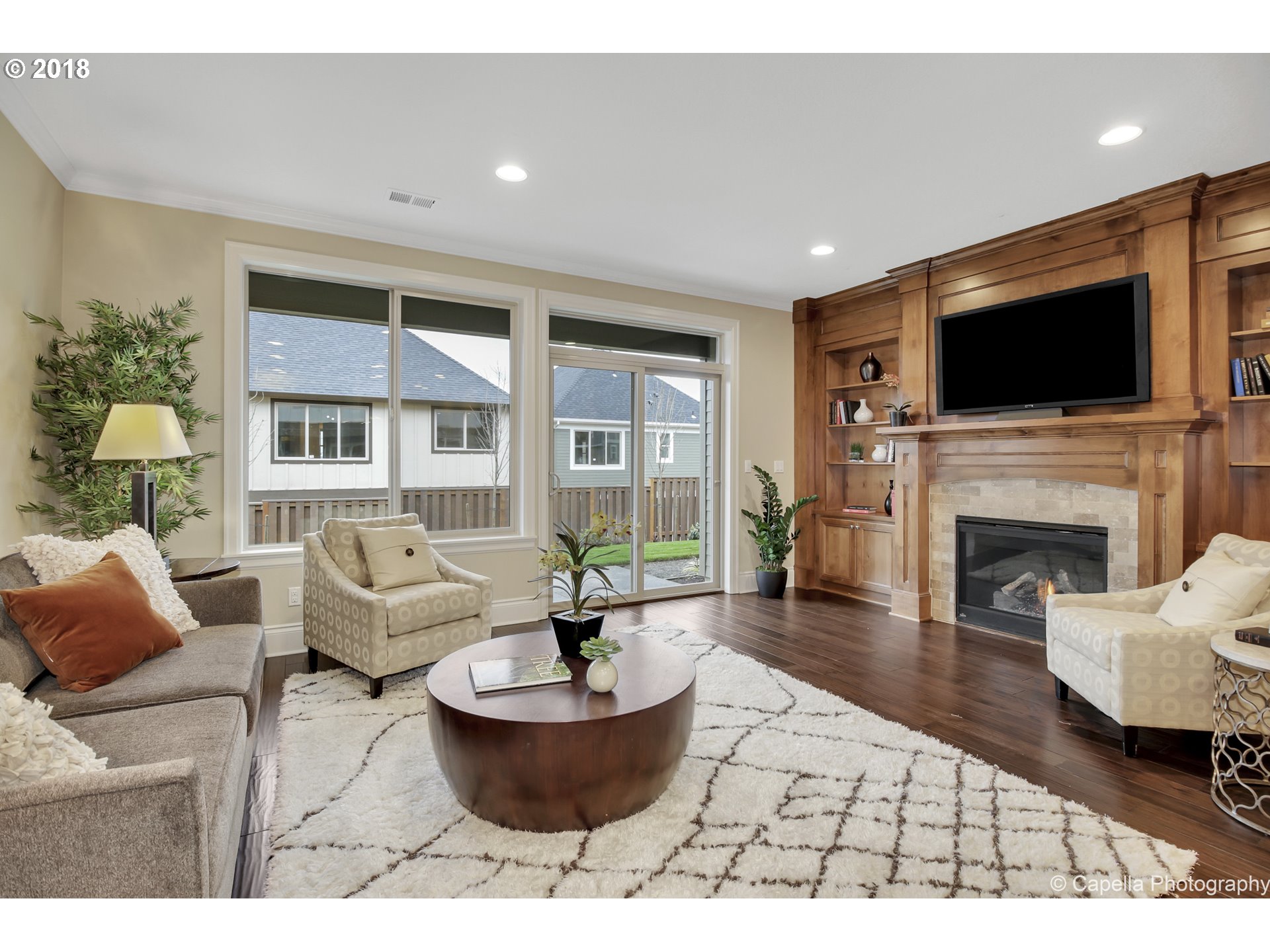 4178 Northwest Ashbrook Drive Portland, OR 97229 - Photo 6 of 20 a living room with furniture a flat screen tv and a fireplace