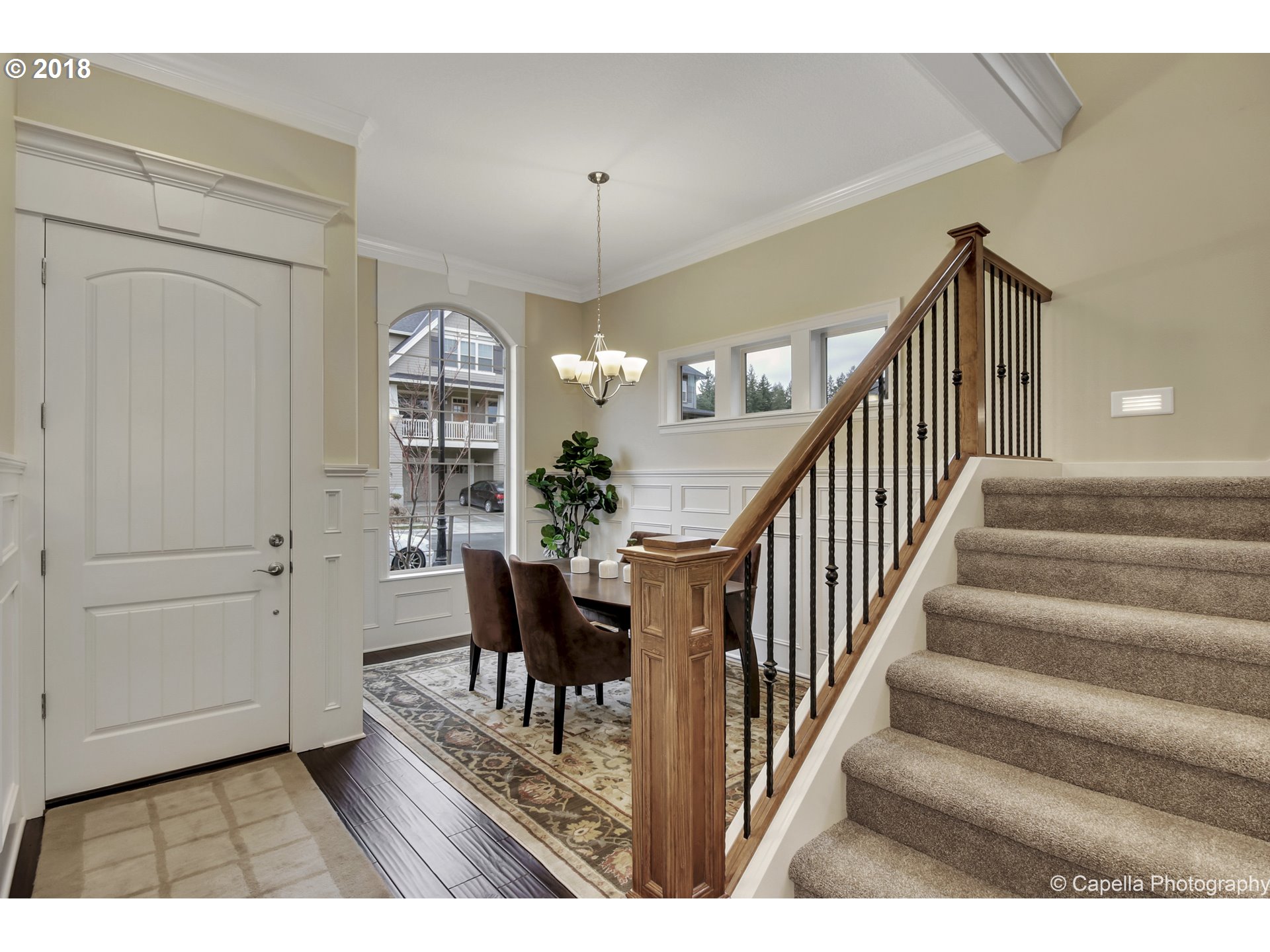 4178 Northwest Ashbrook Drive Portland, OR 97229 - Photo 9 of 20 a view interior of a house with wooden floor windows and a chandelier