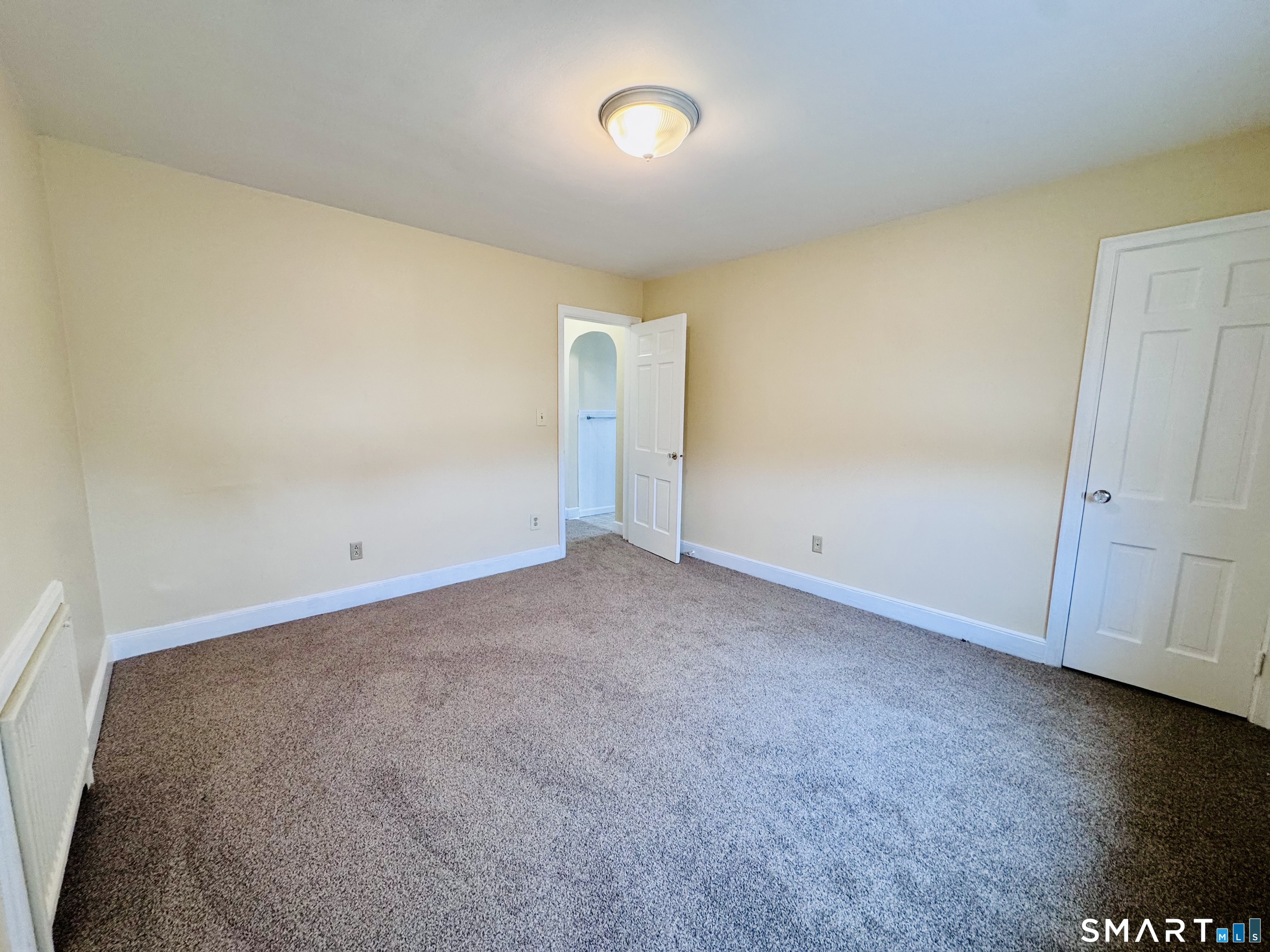 47 Clover Street Stratford, CT 06614 - Photo 11 of 14 an empty room with a door