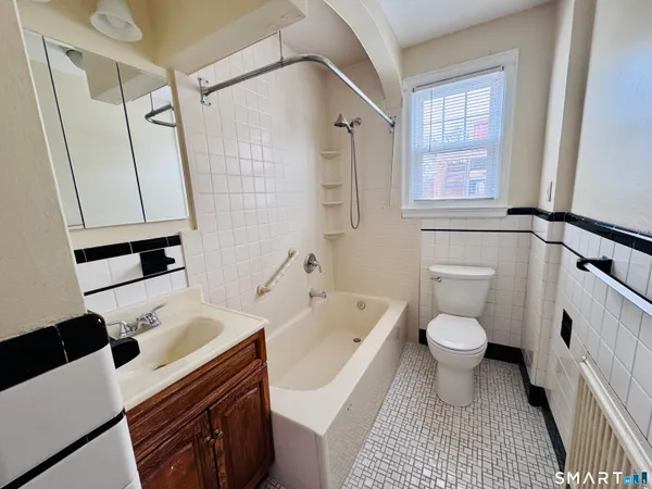 a bathroom with a sink toilet a shower and a mirror