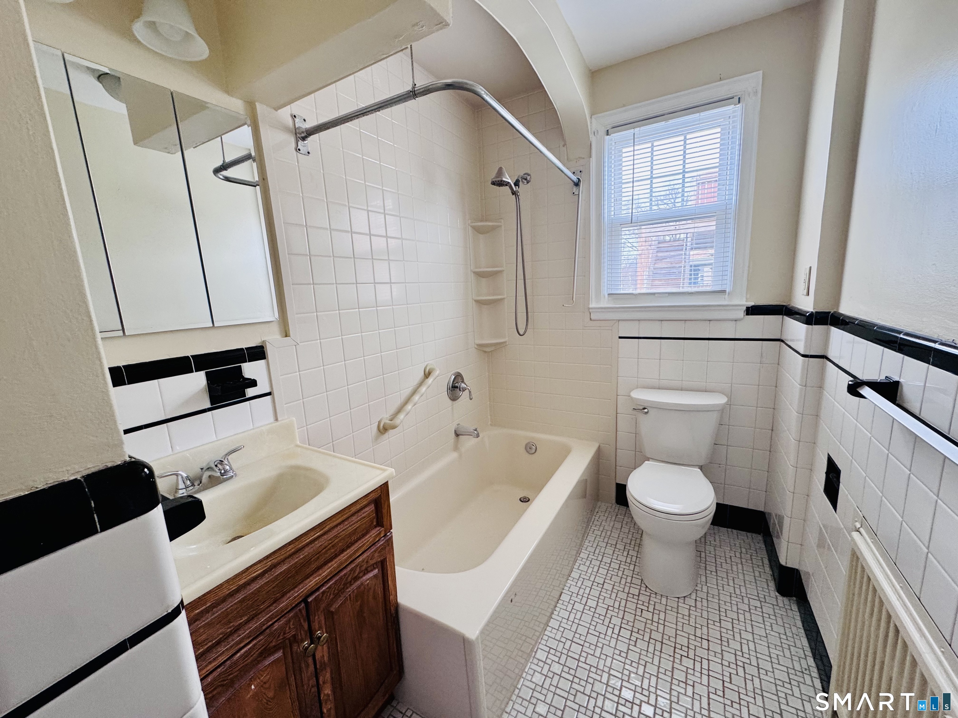 47 Clover Street Stratford, CT 06614 - Photo 12 of 14 a bathroom with a sink toilet a shower and a mirror