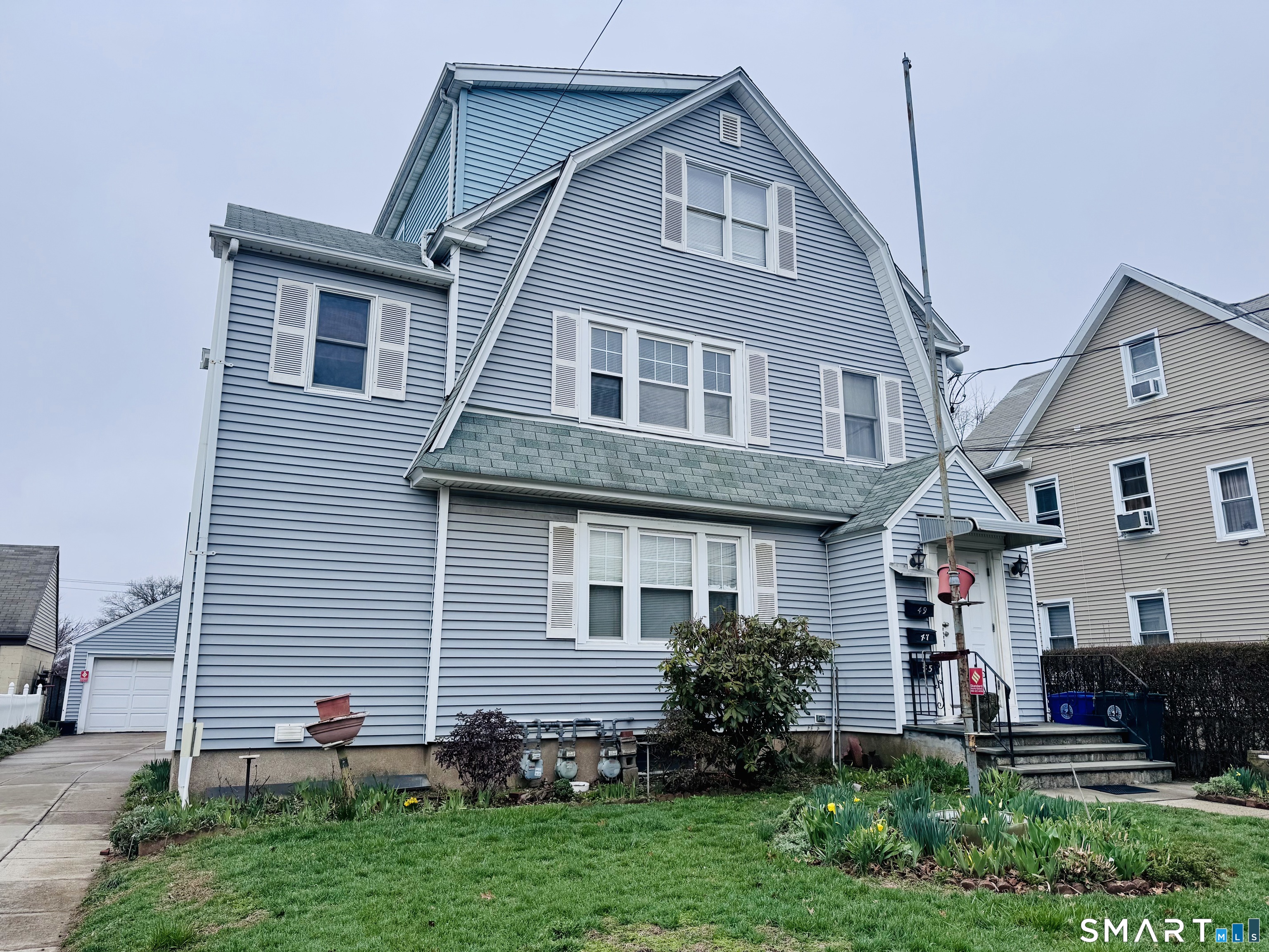 47 Clover Street Stratford, CT 06614 - Photo 2 of 14 a front view of a house with a yard