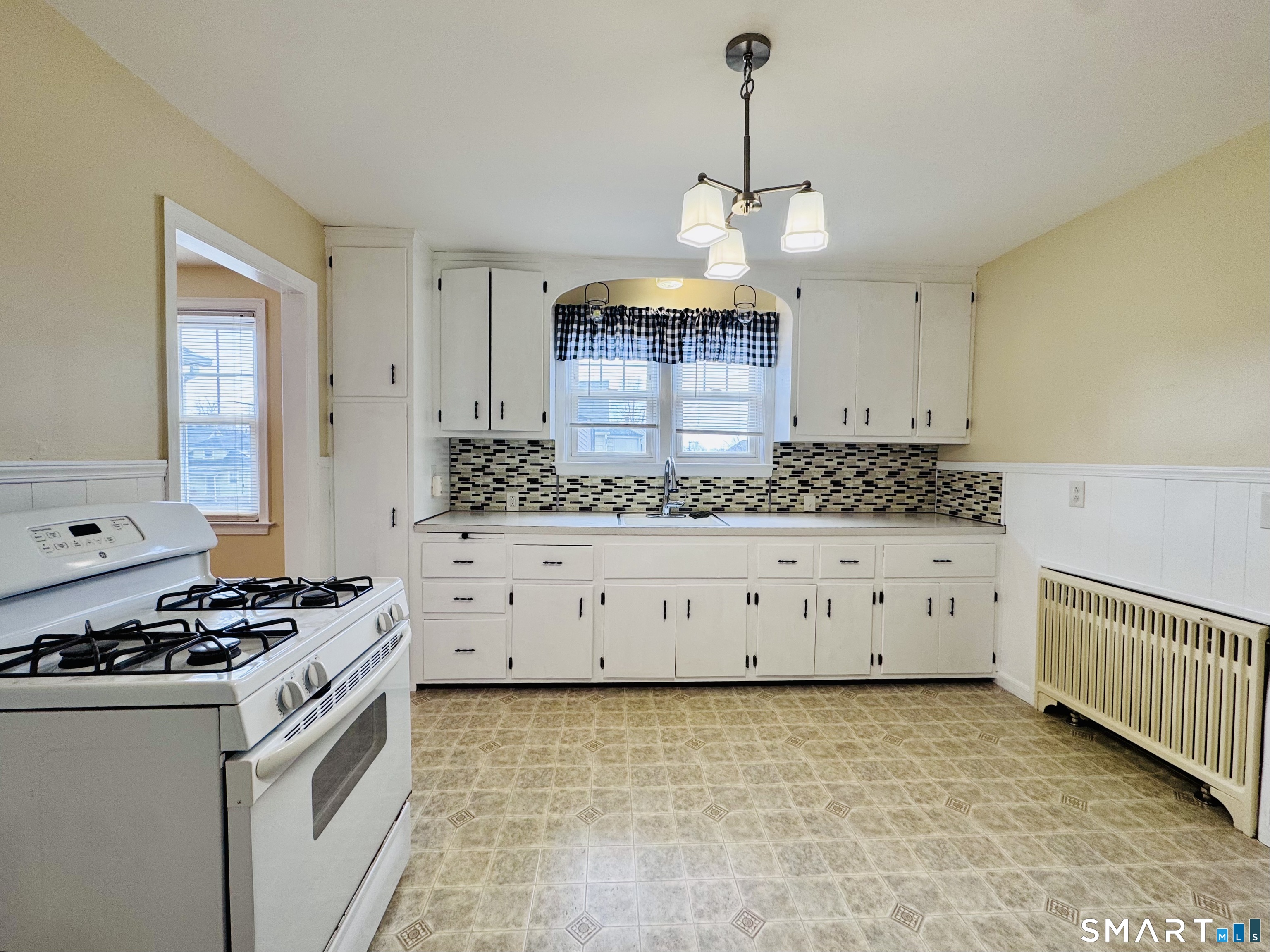 47 Clover Street Stratford, CT 06614 - Photo 3 of 14 a kitchen with granite countertop a stove a sink and a granite counter tops