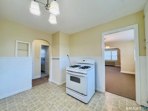 a kitchen with a stove and a chandelier