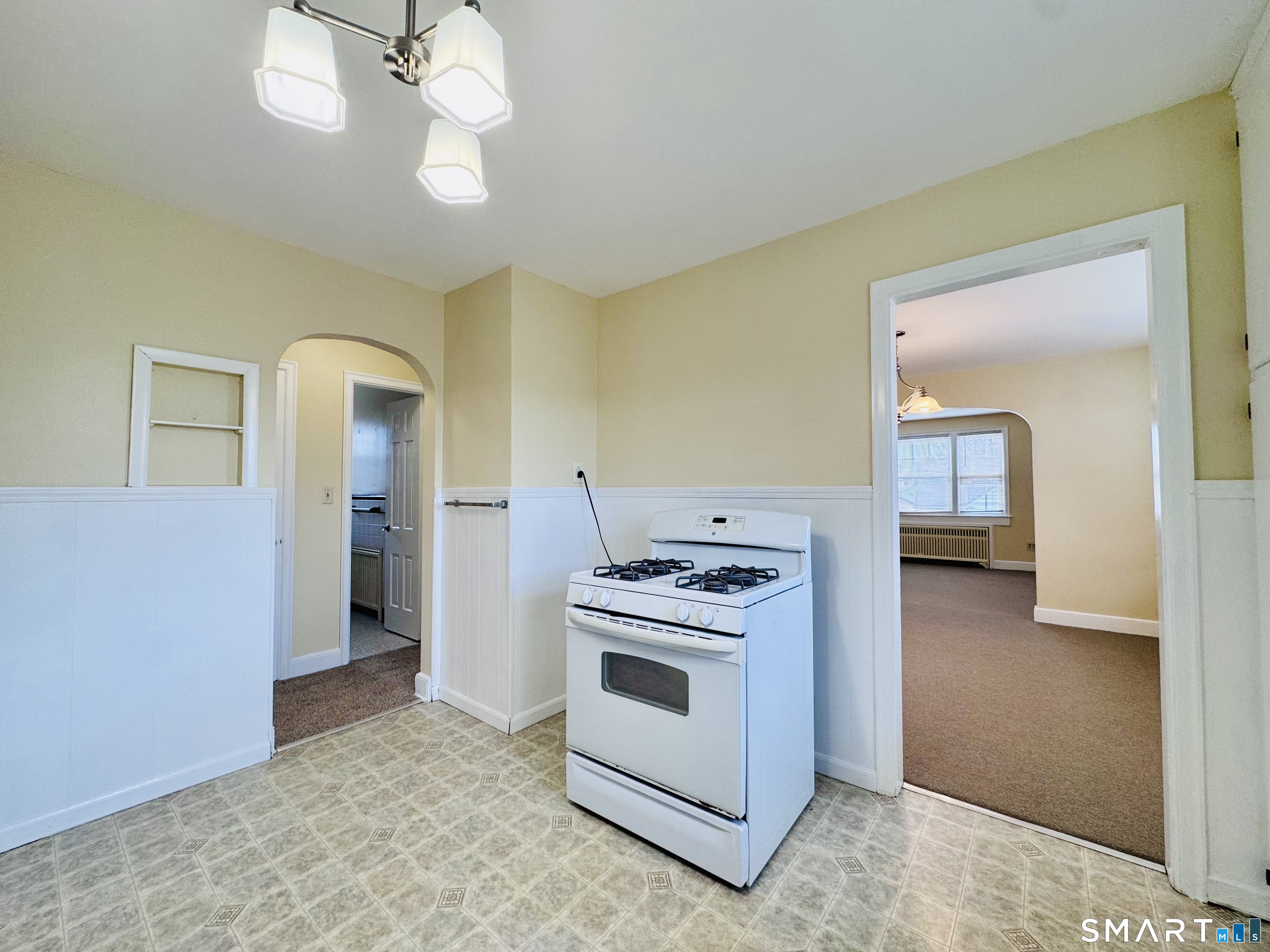 47 Clover Street Stratford, CT 06614 - Photo 4 of 14 a kitchen with a stove and a chandelier