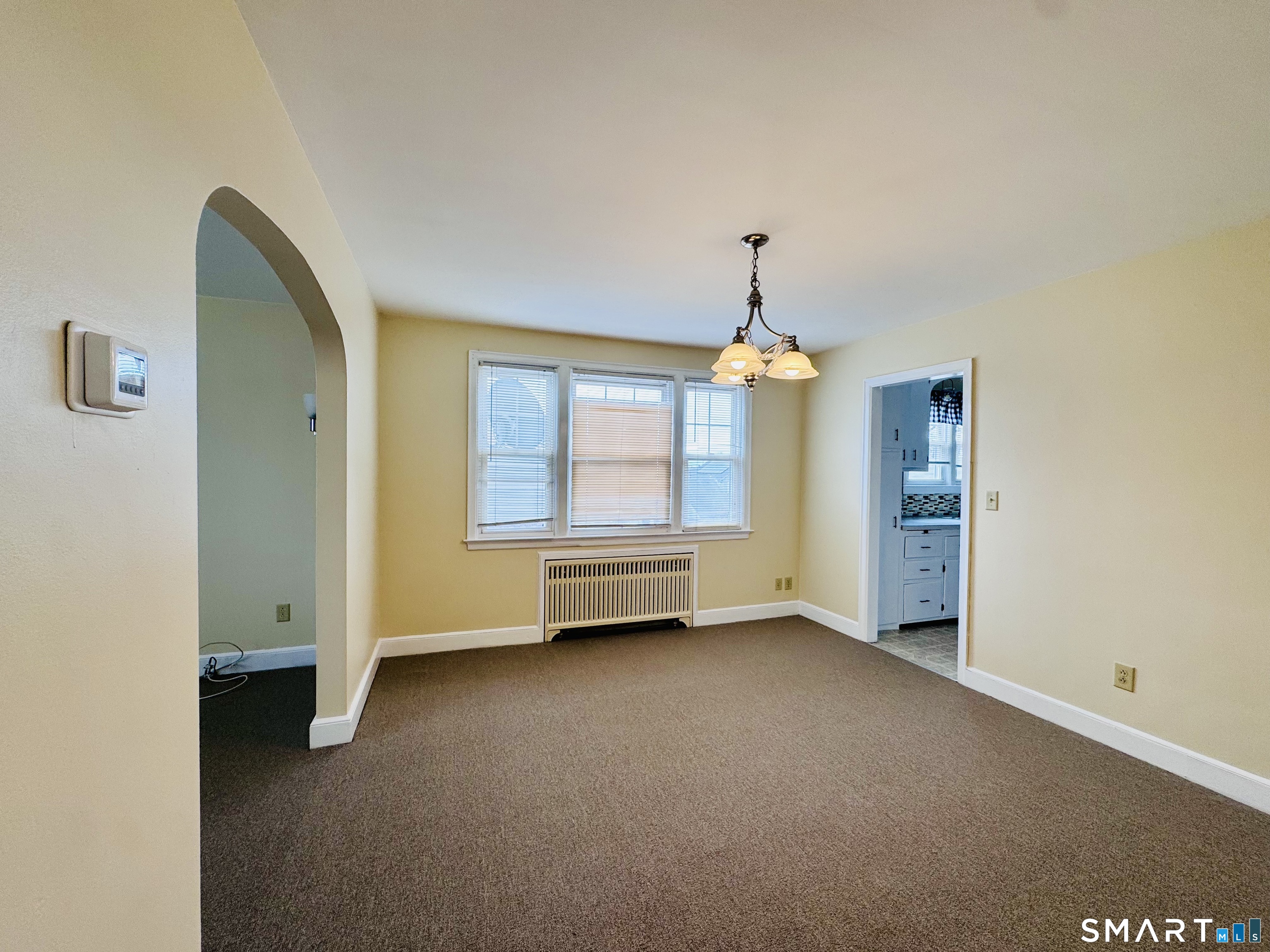 47 Clover Street Stratford, CT 06614 - Photo 7 of 14 an empty room with windows and cabinet