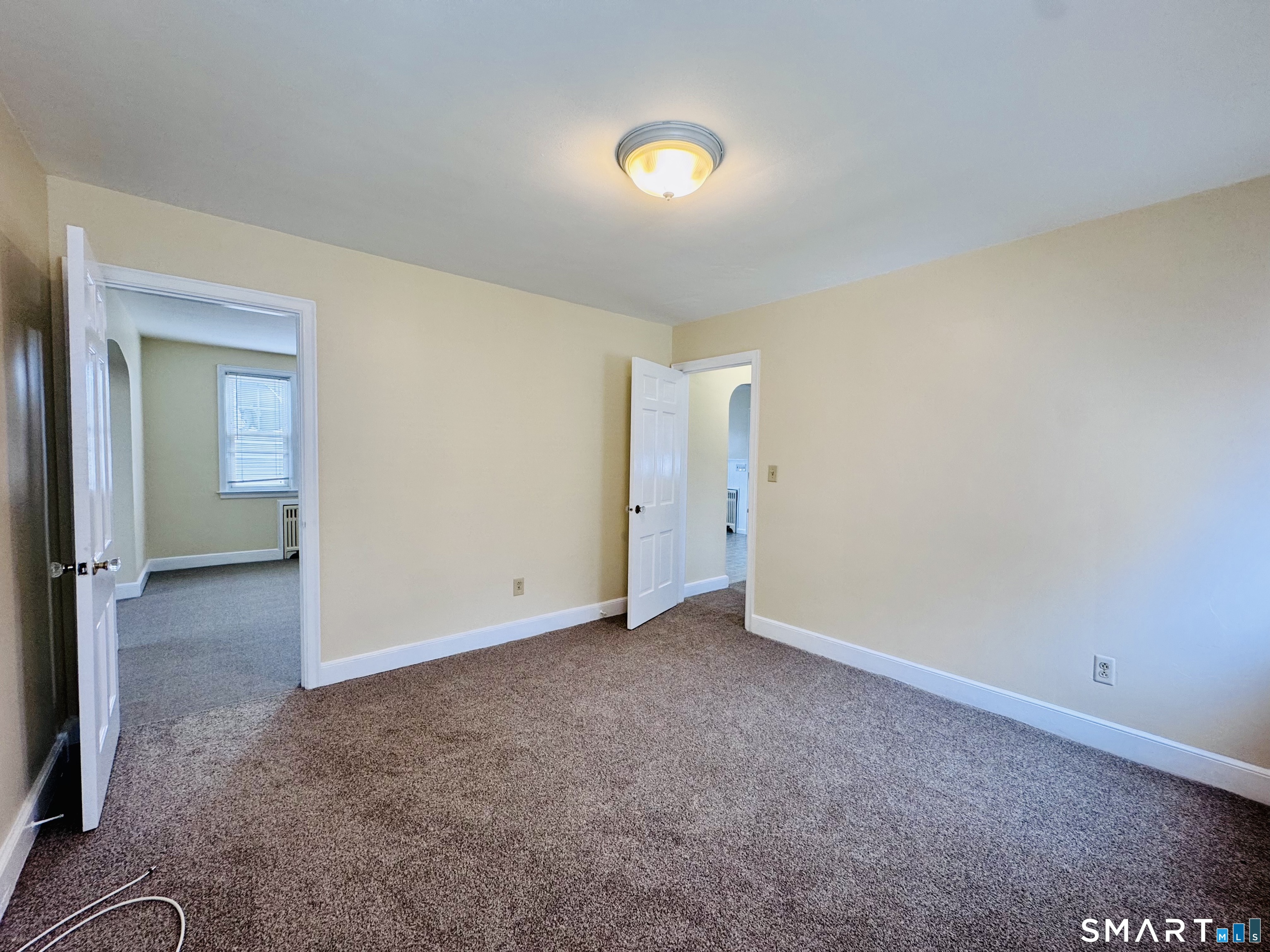 47 Clover Street Stratford, CT 06614 - Photo 8 of 14 an empty room with closet and mirror