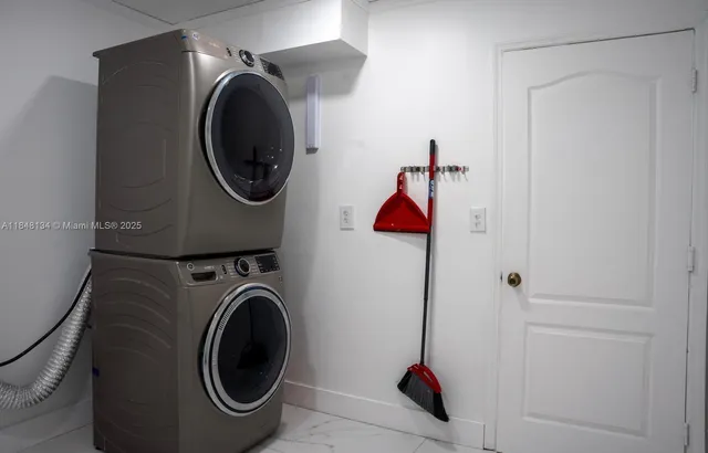 a view of a hallway with wooden floor and stairs