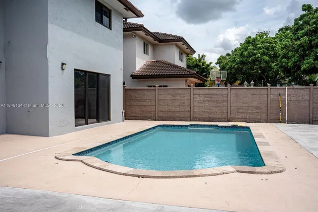 a view of a wooden house with a small backyard