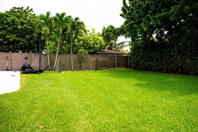 a kitchen with stainless steel appliances kitchen island granite countertop a refrigerator and a sink