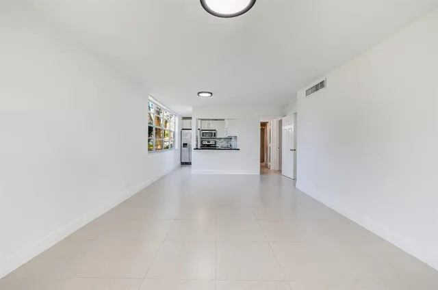 a view of empty room with furniture