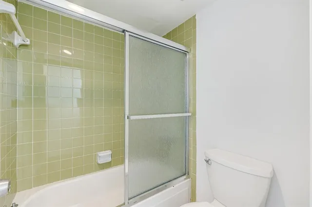 a bathroom with a shower and a toilet