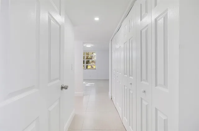 a view of a hallway with wooden shelves