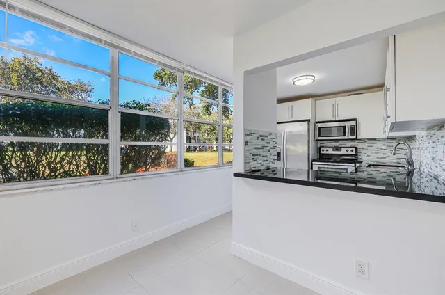 a kitchen with stainless steel appliances a counter space and a window