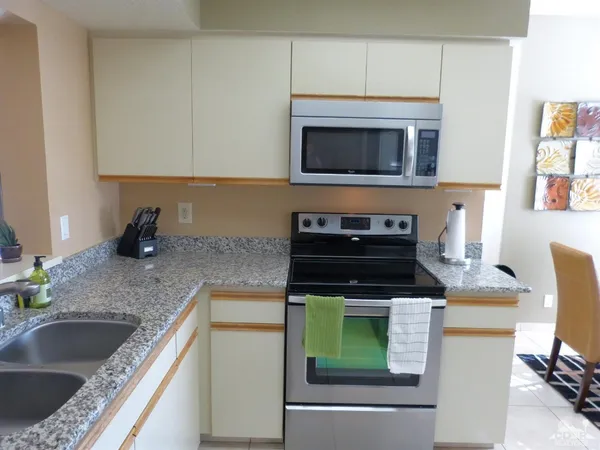 a kitchen with a sink stove and microwave
