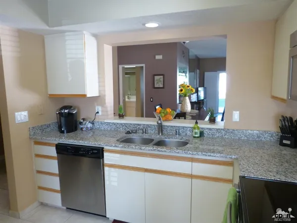 a kitchen with stainless steel appliances granite countertop a sink and a granite counter tops