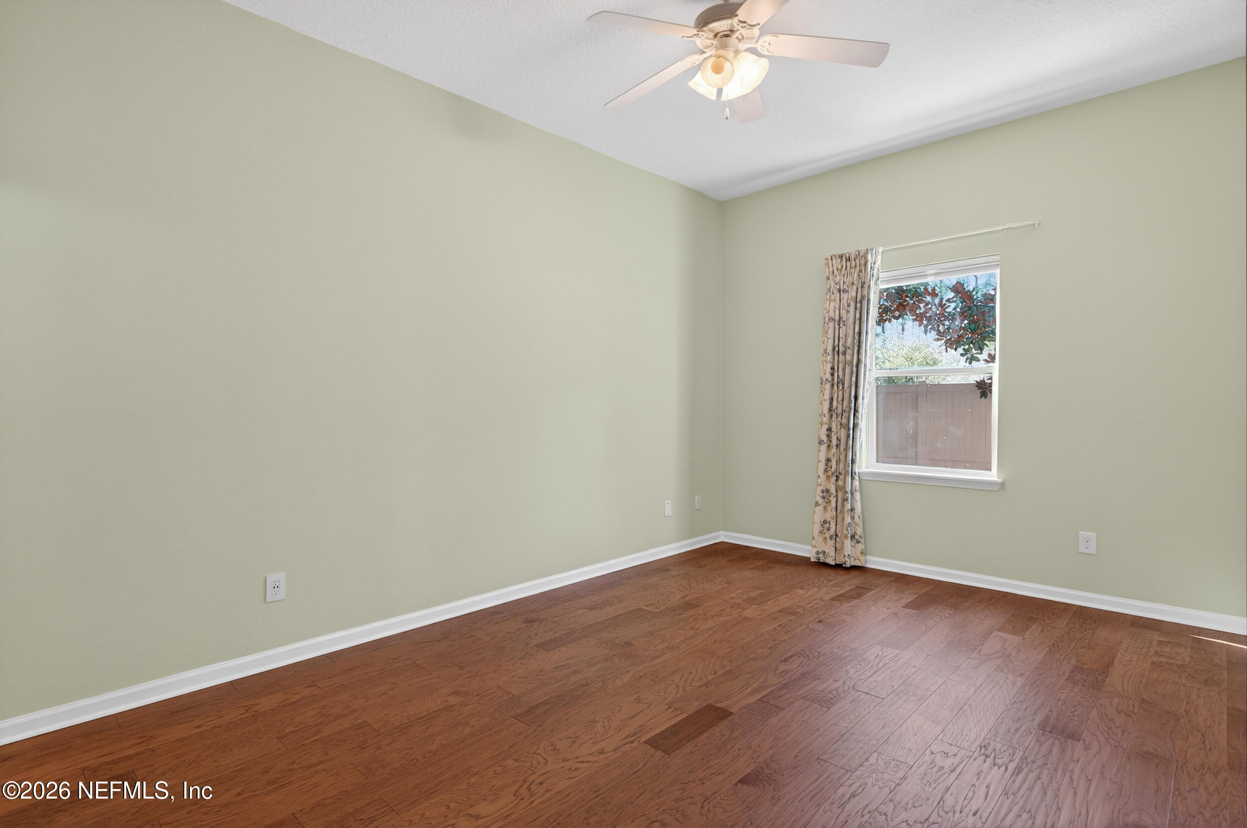 319 Golden Lake Loop St. Augustine, FL 32084 - Photo 5 of 15 an empty room with a window and wooden floor