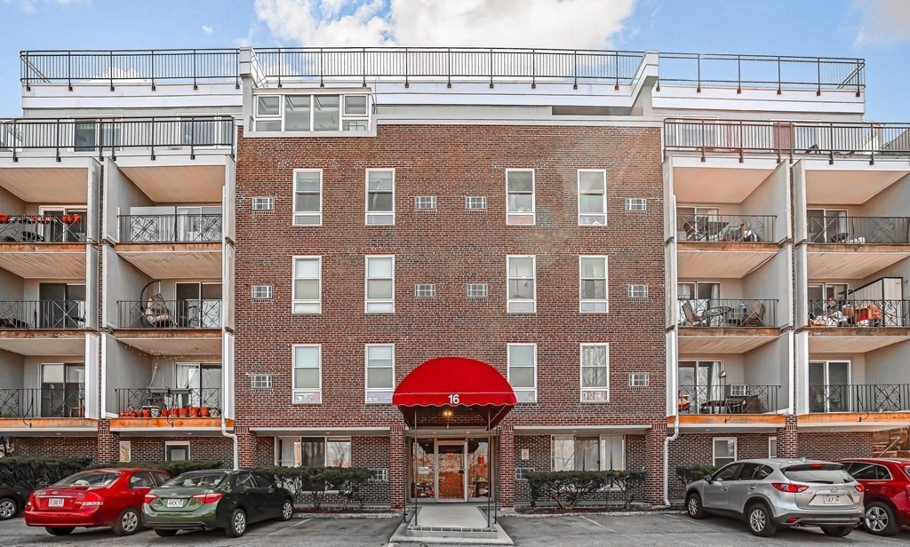 16 Addington Road, Unit 23 Brookline, MA 02445 - Photo 1 of 21 a front view of a building with lot of cars and trees