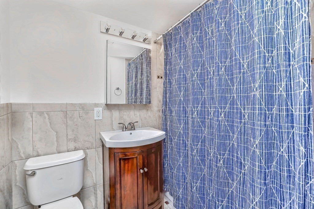 16 Addington Road, Unit 23 Brookline, MA 02445 - Photo 13 of 21 a bathroom with a toilet sink and mirror