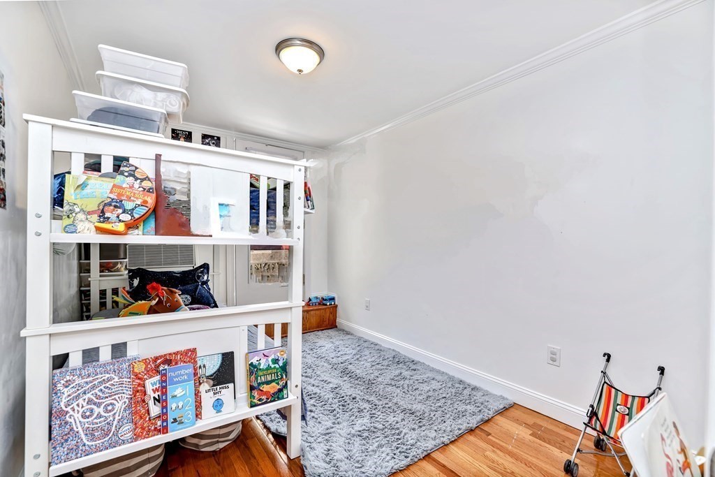 16 Addington Road, Unit 23 Brookline, MA 02445 - Photo 17 of 21 a living room with lots of furniture and baby crib