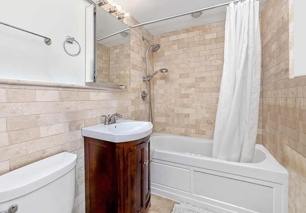16 Addington Road, Unit 23 Brookline, MA 02445 - Photo 18 of 21 a bathroom with a sink a toilet and a bathtub