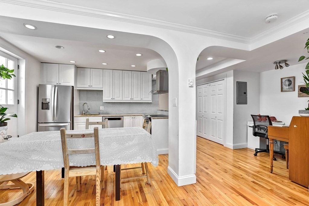 16 Addington Road, Unit 23 Brookline, MA 02445 - Photo 5 of 21 a living room with stainless steel appliances kitchen island granite countertop furniture and wooden floor