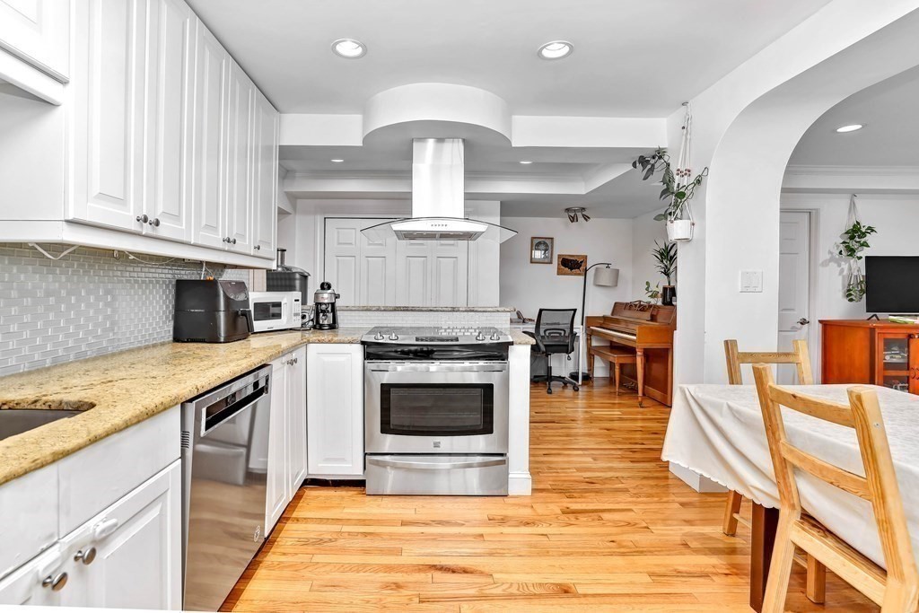 16 Addington Road, Unit 23 Brookline, MA 02445 - Photo 6 of 21 a kitchen with stainless steel appliances granite countertop a stove a sink and a microwave